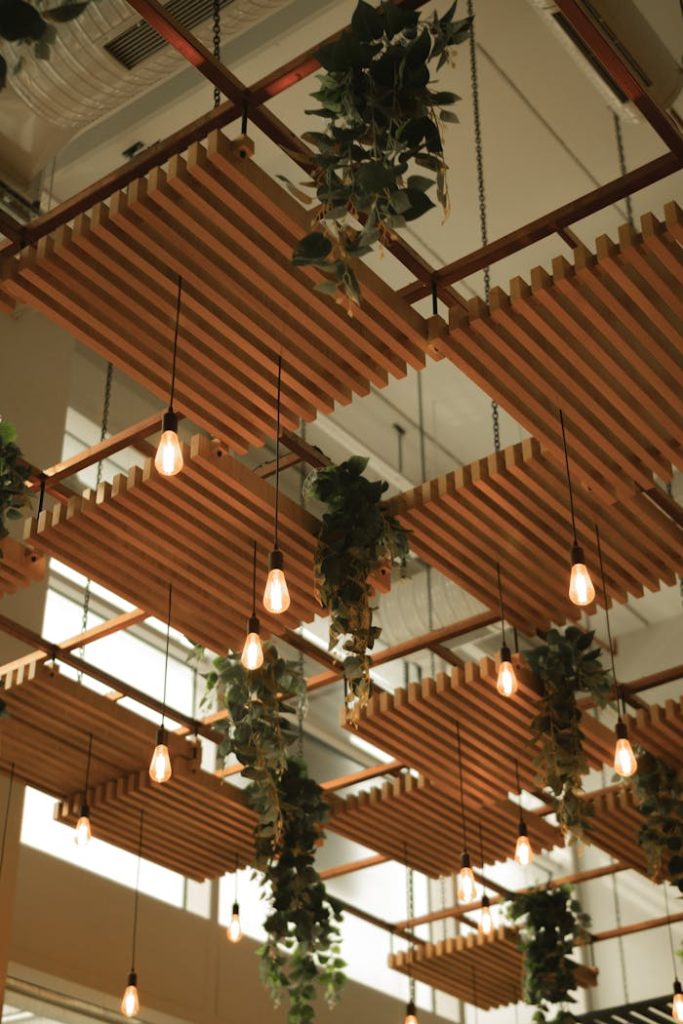 Modern ceiling design with hanging lights and greenery adds elegance to the interior.