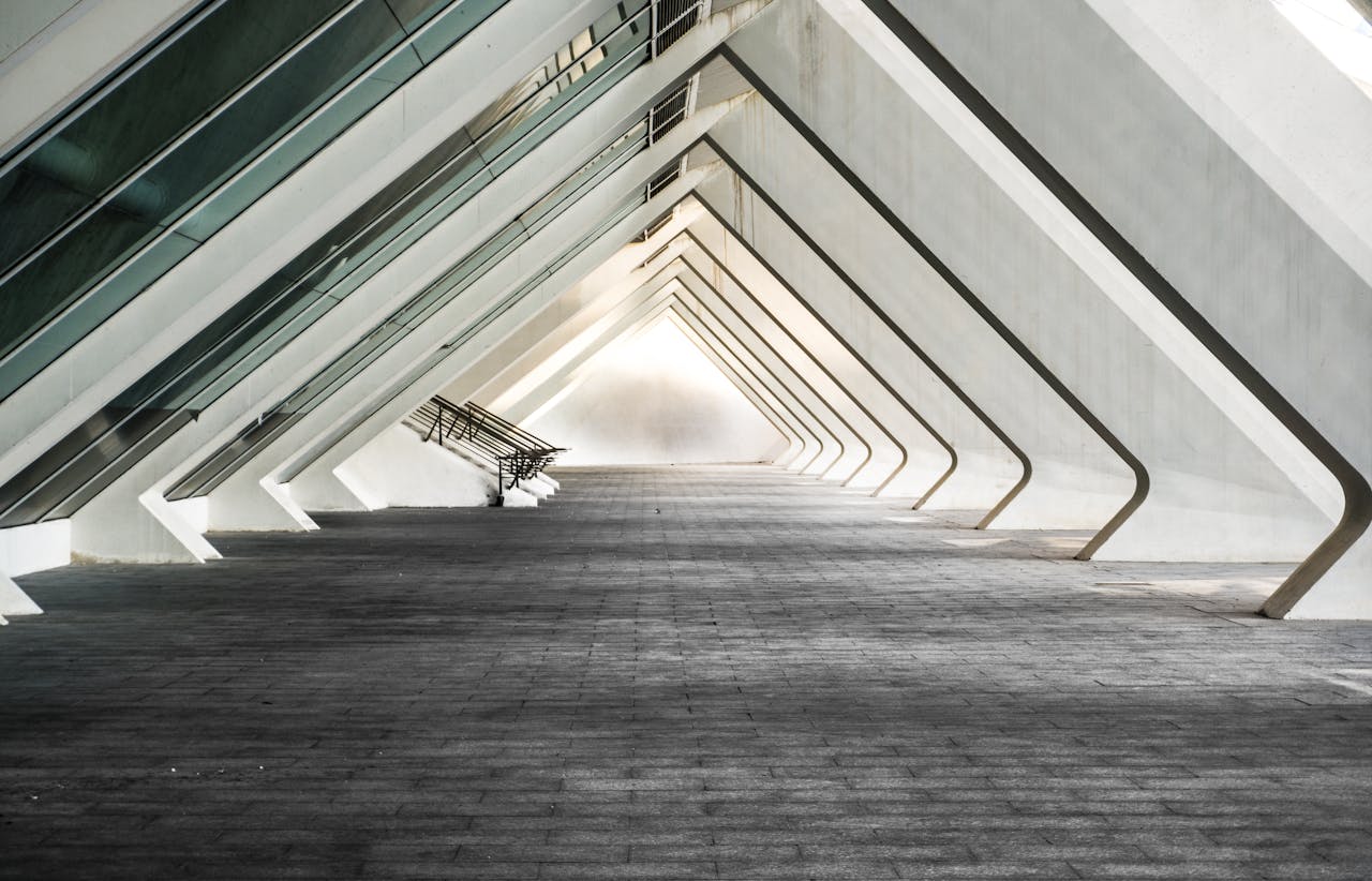 who-we-are-img Explore a sleek and contemporary architectural hallway with futuristic design.